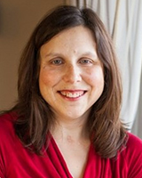 Laurie Proulx a les cheveux mi-longs, raides et bruns. C’est une femme au teint pâle et elle a une petite cicatrice sur la gorge découlant d’une trachéostomie. Elle sourit et on peut voir en arrière-plan son salon, où elle est assise près d’une fenêtre ensoleillée.